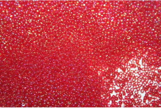 Perline Toho Round Rocailles 15/0, 10gr. Trans-Rainbow Ruby